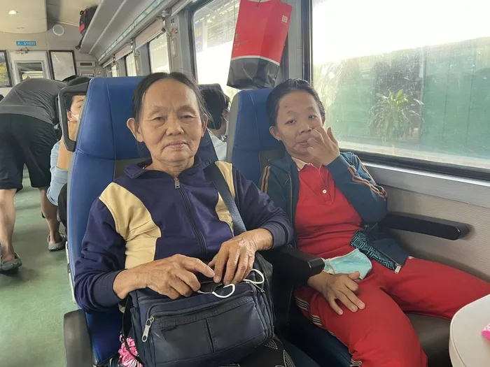  Hai mẹ con bà Đinh Thị Khương vui vì mua được vé tàu về quê đón Tết. Ảnh: TN 